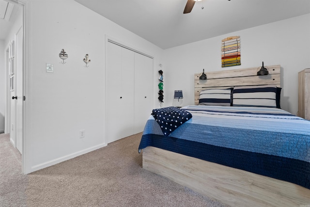 bedroom featuring light colored carpet, a closet, and ceiling fan