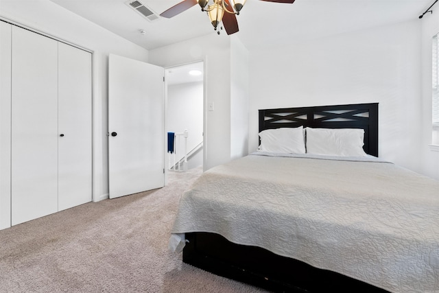 carpeted bedroom with a closet and ceiling fan