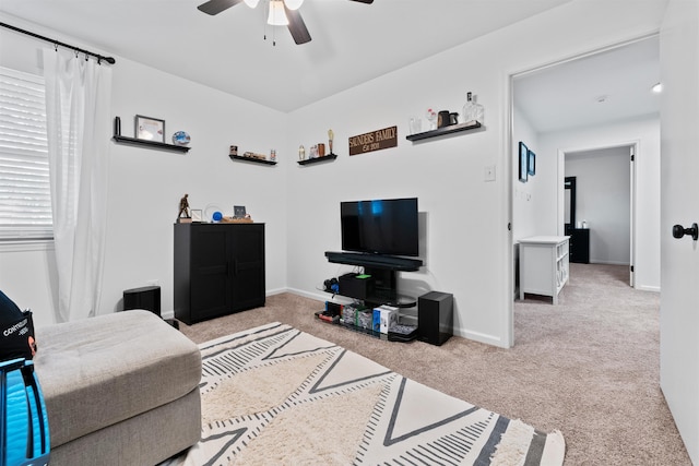 carpeted living room with ceiling fan