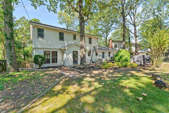 back of house featuring a yard