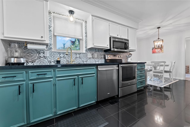 kitchen with tasteful backsplash, stainless steel appliances, decorative light fixtures, dark tile patterned flooring, and white cabinets