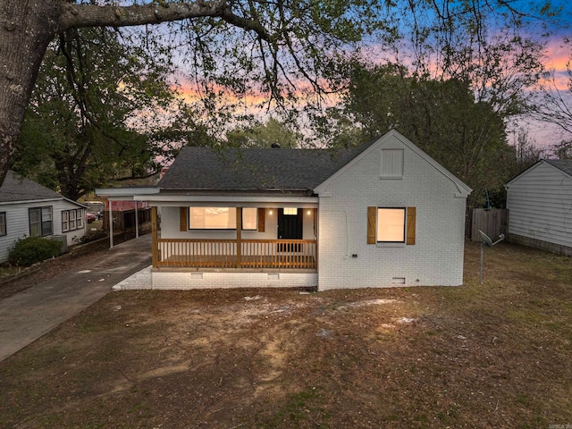 view of front facade with a porch and a carport