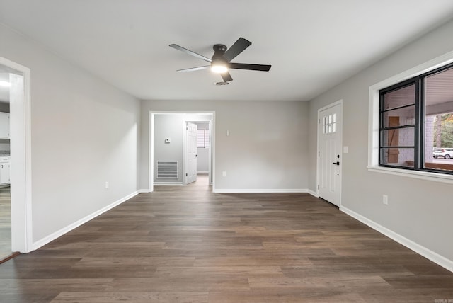 interior space featuring ceiling fan and dark hardwood / wood-style flooring