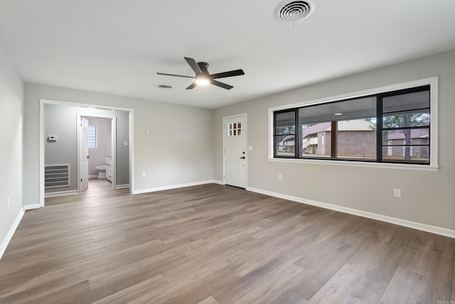 empty room with ceiling fan and hardwood / wood-style flooring