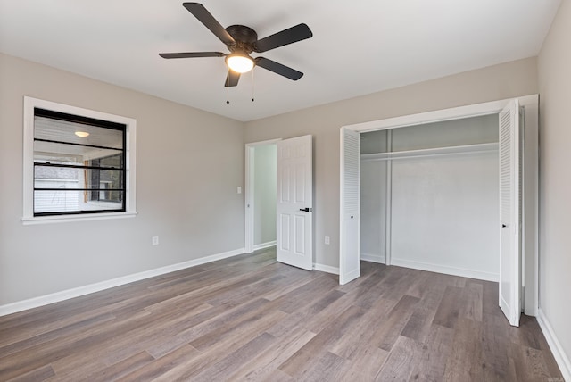 unfurnished bedroom with ceiling fan, a closet, and light wood-type flooring