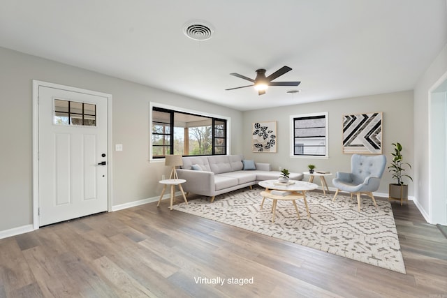 living room with ceiling fan and wood-type flooring