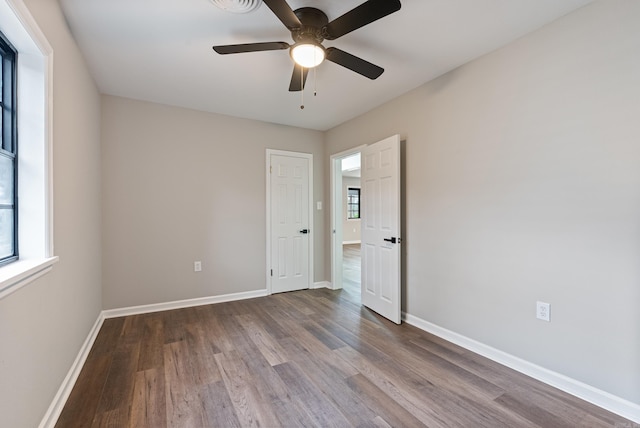 spare room with hardwood / wood-style floors and ceiling fan