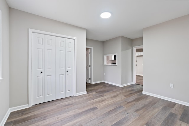 unfurnished bedroom featuring hardwood / wood-style flooring and a closet