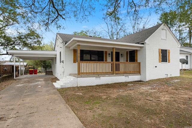 view of front of property with a porch and a carport