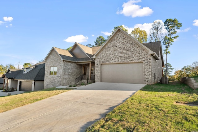 view of front of house featuring central AC, a front yard, and a garage