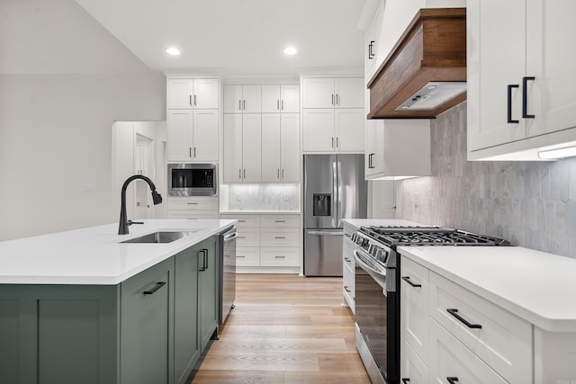 kitchen with sink, stainless steel appliances, tasteful backsplash, light hardwood / wood-style floors, and custom exhaust hood