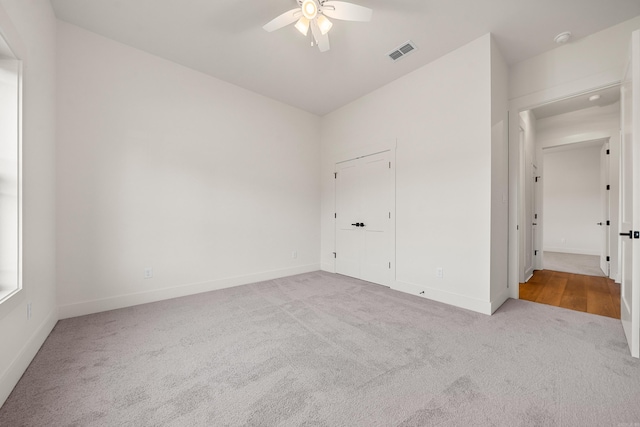 unfurnished bedroom with ceiling fan and light carpet