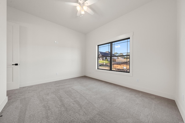 carpeted spare room featuring ceiling fan