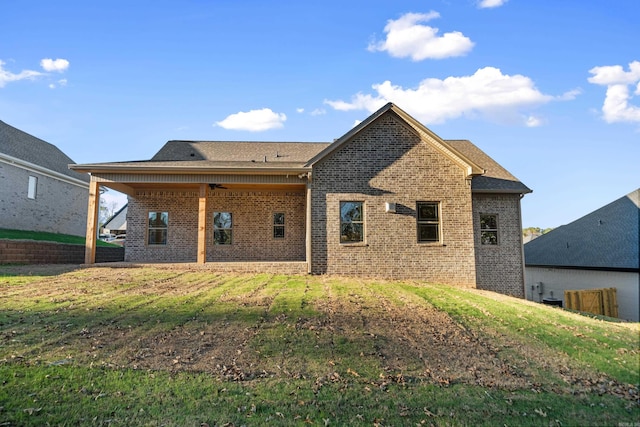 rear view of house featuring a yard