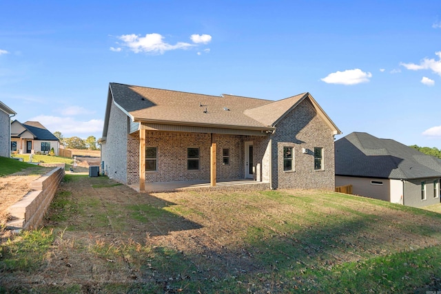 back of property featuring a lawn, a patio area, and cooling unit