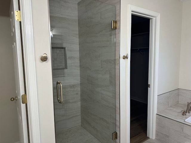 bathroom with hardwood / wood-style flooring and separate shower and tub