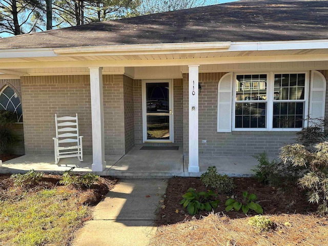 view of exterior entry with covered porch