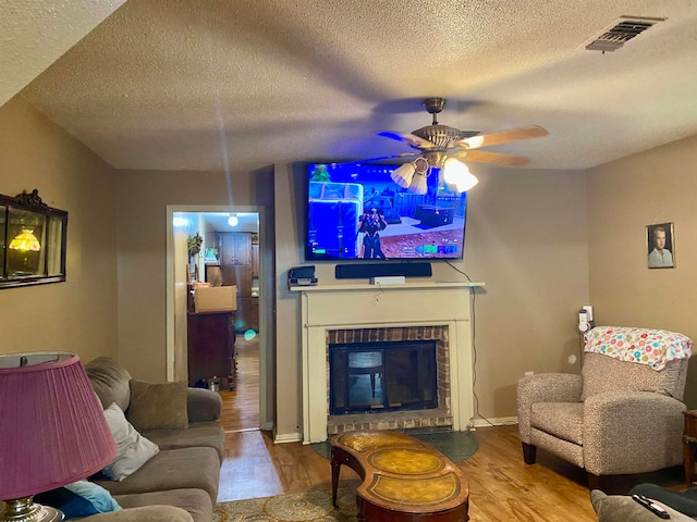 living room with a textured ceiling and light wood-type flooring