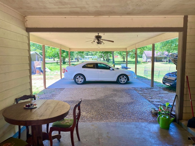 view of parking / parking lot with ceiling fan and a lawn