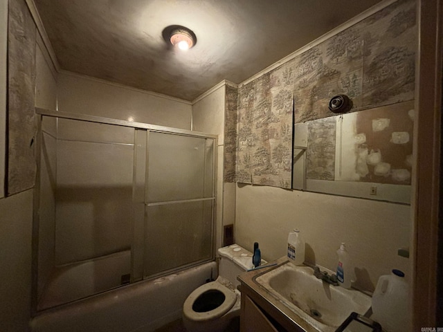 full bathroom featuring shower / bath combination with glass door, vanity, ornamental molding, and toilet