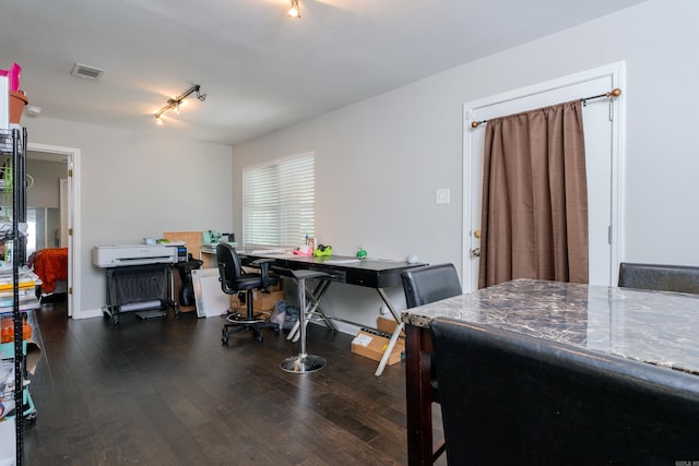 dining space featuring dark hardwood / wood-style floors, a healthy amount of sunlight, and track lighting