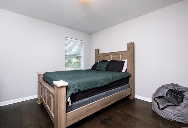 bedroom featuring dark hardwood / wood-style flooring