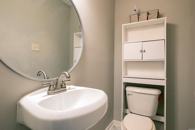 bathroom with toilet and sink