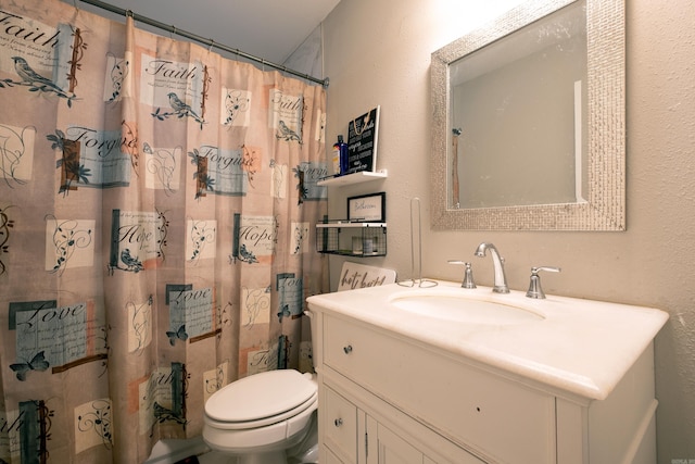 bathroom featuring vanity, curtained shower, and toilet