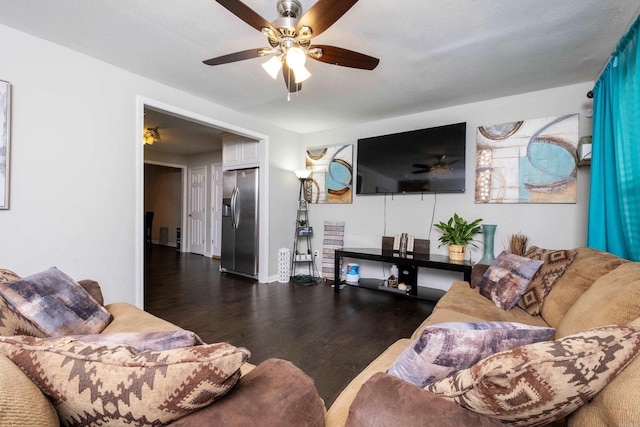 living room with a textured ceiling, ceiling fan, and dark hardwood / wood-style floors