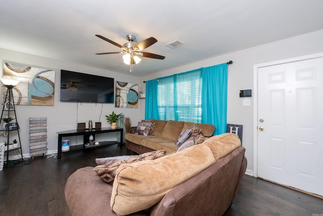 living room featuring ceiling fan and dark wood-type flooring