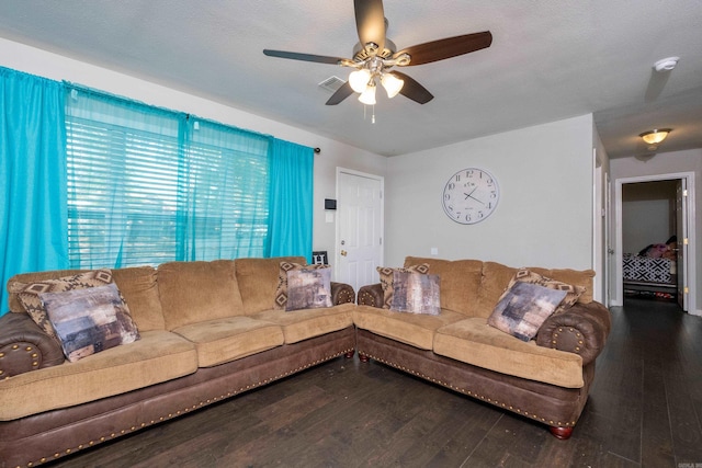 living room featuring hardwood / wood-style floors, ceiling fan, and a textured ceiling