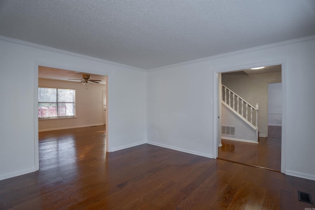 unfurnished room with a textured ceiling, ceiling fan, crown molding, and dark wood-type flooring