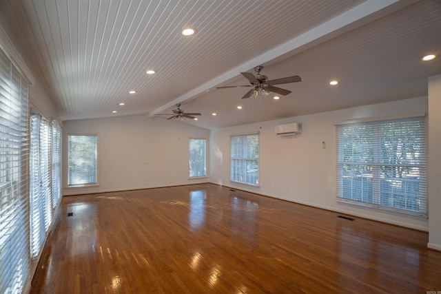 empty room with a wall mounted air conditioner, vaulted ceiling with beams, dark hardwood / wood-style floors, and a wealth of natural light