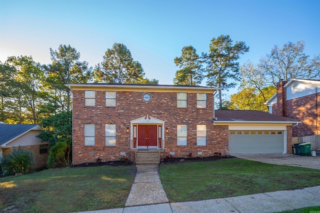125 Pebble Beach Dr, Little Rock, AR 72212 - colonial-style house with driveway, a front lawn, an attached garage, and brick siding