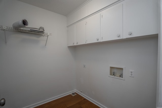 washroom featuring electric dryer hookup, cabinets, washer hookup, a textured ceiling, and dark hardwood / wood-style flooring