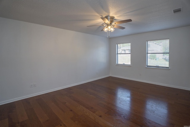 spare room featuring a textured ceiling, ceiling fan, and dark hardwood / wood-style floors