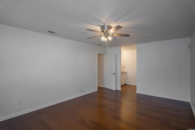 unfurnished room with dark hardwood / wood-style floors, ceiling fan, and a textured ceiling