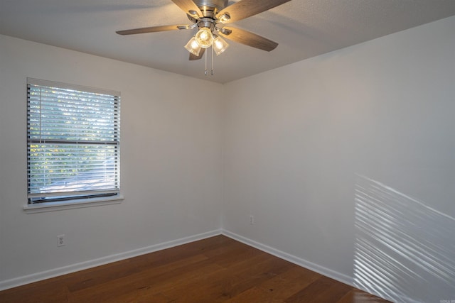 spare room featuring dark hardwood / wood-style flooring and ceiling fan