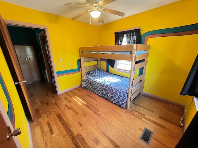 bedroom with hardwood / wood-style floors and ceiling fan