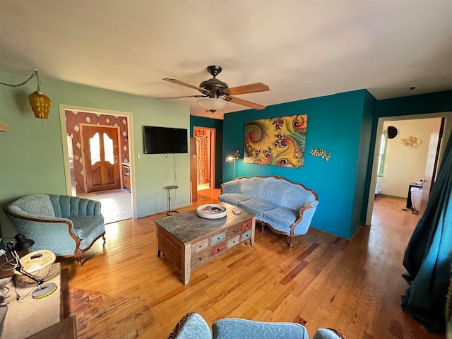 living room featuring light hardwood / wood-style flooring and ceiling fan