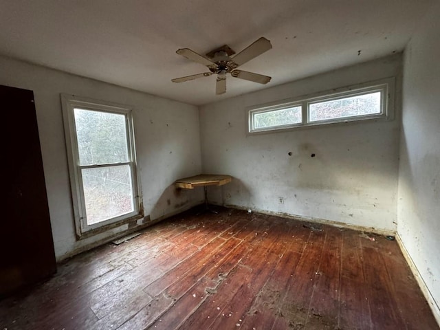 unfurnished room featuring ceiling fan and dark hardwood / wood-style flooring