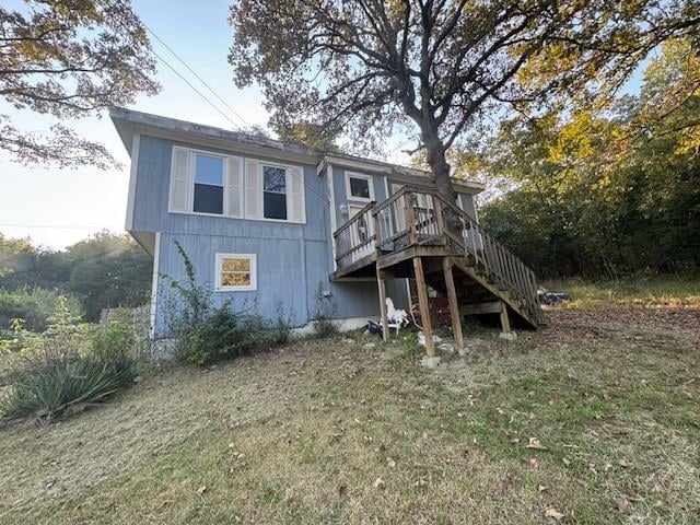 rear view of property featuring a deck