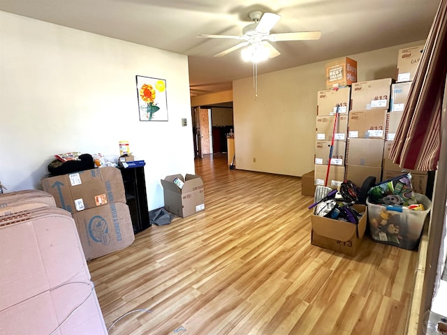 living room with ceiling fan and light hardwood / wood-style flooring