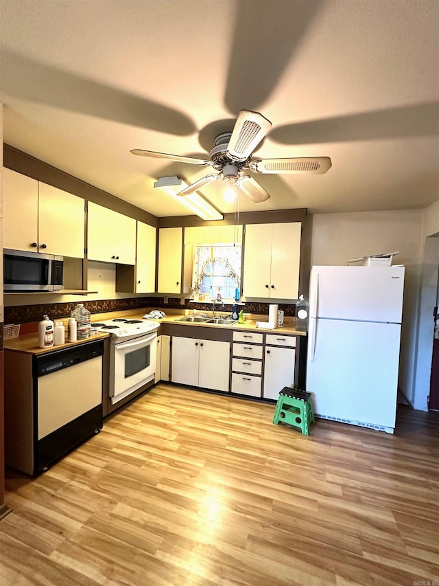 kitchen featuring ceiling fan, white cabinetry, light wood-type flooring, and white appliances