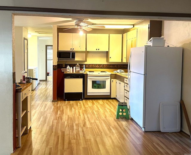 1107 Glenaire St, Mena, AR 71953 - kitchen with white appliances, ceiling fan, and light wood-style flooring