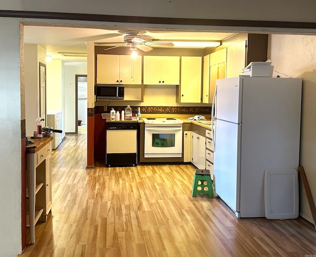 kitchen featuring ceiling fan, light wood-type flooring, and white appliances