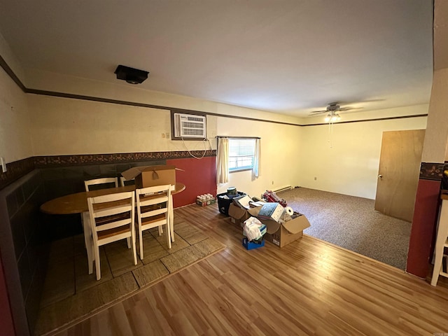 1107 Glenaire St, Mena, AR 71953 - unfurnished dining area with a ceiling fan, wood finished floors, and a wall mounted AC