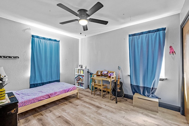 bedroom with ceiling fan and hardwood / wood-style flooring