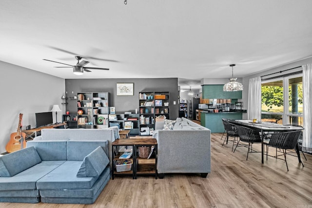 living room featuring ceiling fan and wood-type flooring