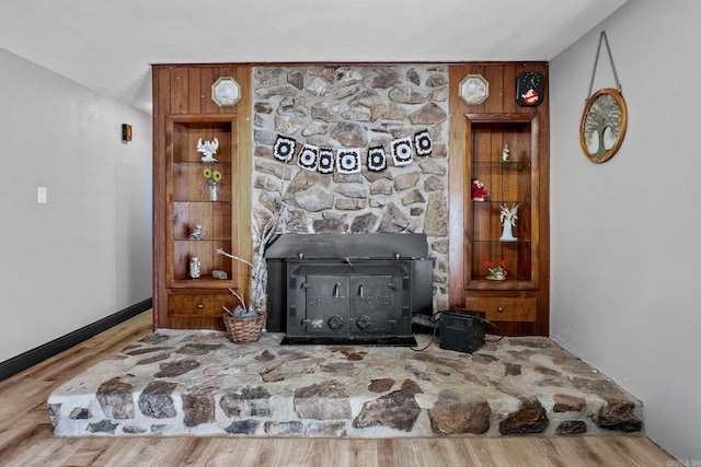 living room with hardwood / wood-style flooring and a wood stove